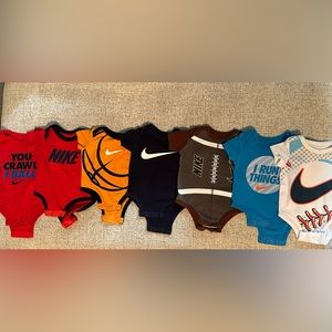 Nike Bundle Includes 7 onesies in size 0-3 month.